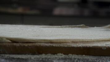 Hand throw a piece of dough. Scene. Man baking bread. Sprinkling some flour on dough. Hands kneading dough. Close up of mans hands kneading the dough in restaurant video