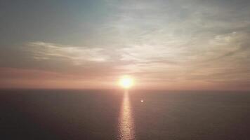 Panorama of beautiful sunset on the ocean. Video. View of sunset seascape in the middle of the ocean. Aerial video