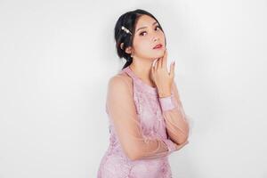 Portrait of a young beautiful Asian woman wearing a pink dress, beauty shoot concept photo