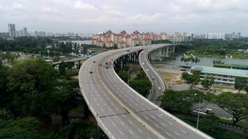 Panoramic aerial view of river bridge in the city with trees in parks. Shot. Aearial view of the bridge with cars crossing a beautiful river and modern cityscape. video