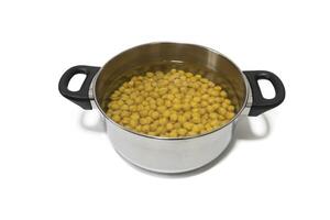 A pot with soaking chickpeas, isolated on a white background, close-up. photo