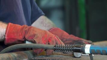 Hand Ironworker forging hot iron in workshop whith hammer. Hands of blacksmith making horseshoe video