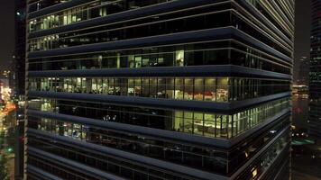 Singapore - 25 September 2018. Bright and beautiful lights reflection in night windows of business building with glass facade. Shot. Beautiful lights reflection at night, windows office building video