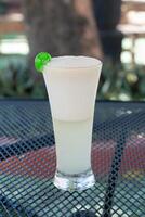 a glass of soursop juice decorated with a cherry photo