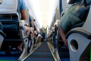 Airplane background selective focus. Blur. The passage between the seats inside the aircraft cabin. Passengers are ready to fly. photo