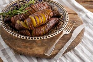 Sweet potato - sweet potato tubers cooked in a pan. Fried and baked with spices and salt. Cut into pieces and slices. Healthy food close-up top view. photo