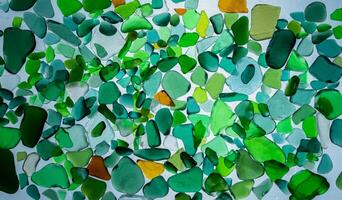 Summer background from sea glass top view. Broken glass from the ocean. Sea pattern. Oceanic mosaic. Natural colors of blue, green, white found on the coast photo