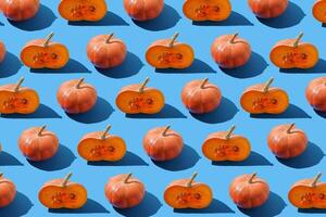 Pattern of pumpkins on a blue background. Autumn harvest. Pumpkin. Thanksgiving Day. Food for Halloween photo