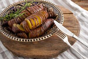 Sweet potato - sweet potato tubers cooked in a pan. Fried and baked with spices and salt. Cut into pieces and slices. Healthy food close-up top view. photo