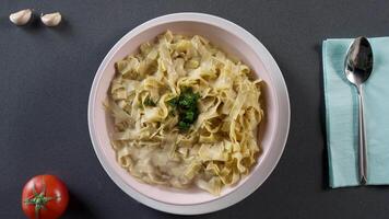 Pasta fettuccine alfredo with chicken, parmesan and parsley. Scene. Pasta fettuccine with mushrooms and fried chicken ham in creamy cheese sauce. Italian cuisine. Portion of fettuccine Alfredo video