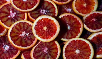 Red oranges fruit background. Sliced juicy orange. Food. Summer concept. Close-up on the light photo