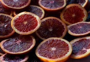 Red oranges fruit background. Sliced juicy orange. Food. Summer concept. Close-up on the light photo