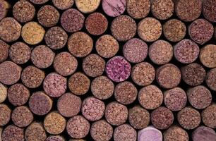 Wine background. Lots of bottle caps. Bark cork. Wine bottle corks photo