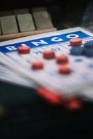 Close-up View of a Bingo Card and Red Markers During a Game Session photo