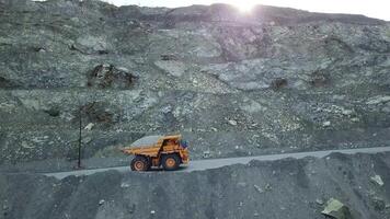 Dump truck loaded with chalk moving on a quarry road. Quarry and mining equipment. video