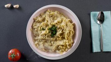 Pasta fettuccine alfredo with chicken, parmesan and parsley. Scene. Pasta fettuccine with mushrooms and fried chicken ham in creamy cheese sauce. Italian cuisine. Portion of fettuccine Alfredo video