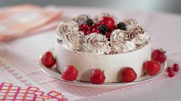 Cake with whipped cream and strawberries on a stand, close-up. Scene. Sliced No Bake Strawberry Cheesecake Decorated with Fresh Berries. Homemade cake made from cream with strawberries and raspberries video