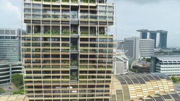 Singapur - 25 septiembre 2018. cerca arriba ver para vertical bosque edificio en el centrar de el ciudad, naturaleza ahorro concepto. disparo. moderno, extraordinariamente diseñado edificio con muchos arboles en el balcones video