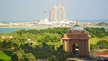 Abu Dhabi, United Arab Emirates - December 4, 2023. Aerial view of gate to the Emirates Palace hotel and Rixos hotel on background in Abu Dhabi, UAE. High quality 4k footage video