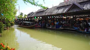 Pattaya, Thailand - December 29, 2023. Floating open air market with small houses - shops on the pond in Pattaya, Thailand. High quality 4k footage video