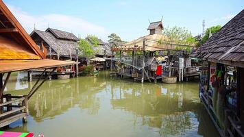 Pattaya, Thailand - December 29, 2023. Floating open air market with small houses - shops on the pond in Pattaya, Thailand. High quality 4k footage video