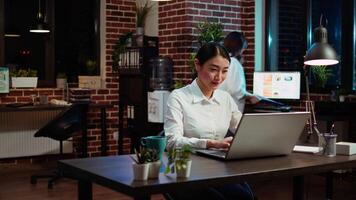 Zoom in on company accountant typing down financial notes on laptop and analyzing sales report to plan business development. Office employee using computer to do project research video