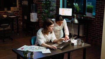 Cheerful coworkers read email on laptop received from customer, excited after managing to secure lucrative deal for company. Colleagues celebrate finalizing agreement with business partners, camera A video