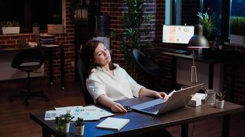 cansado empleado dormido en espacio de trabajo escritorio, despertar por gerente, disculparse sí misma. soñoliento mujer de negocios despertado arriba por equipo líder después siesta en oficina trabajando durante la noche, sensación avergonzado, cámara un video