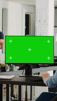 vertikal video affärskvinna ser på grönskärm visa till arbete på byrå uppgifter, anställd analyserar isolerat Chromakey mall på skrivbordet. person arbetssätt med copyspace, problem lösning.