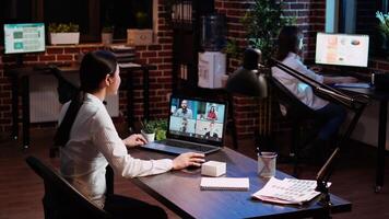 Businesswoman talking with board of directors during business meeting on videocall in office. Employee speaking in remote videoconference telework call, receiving feedback from management video