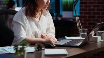 Employee calls manager remotely using internet videocall to ask for feedback on project progress. Worker in brick wall office requesting assistance from team leader in teleconference meeting, camera B video