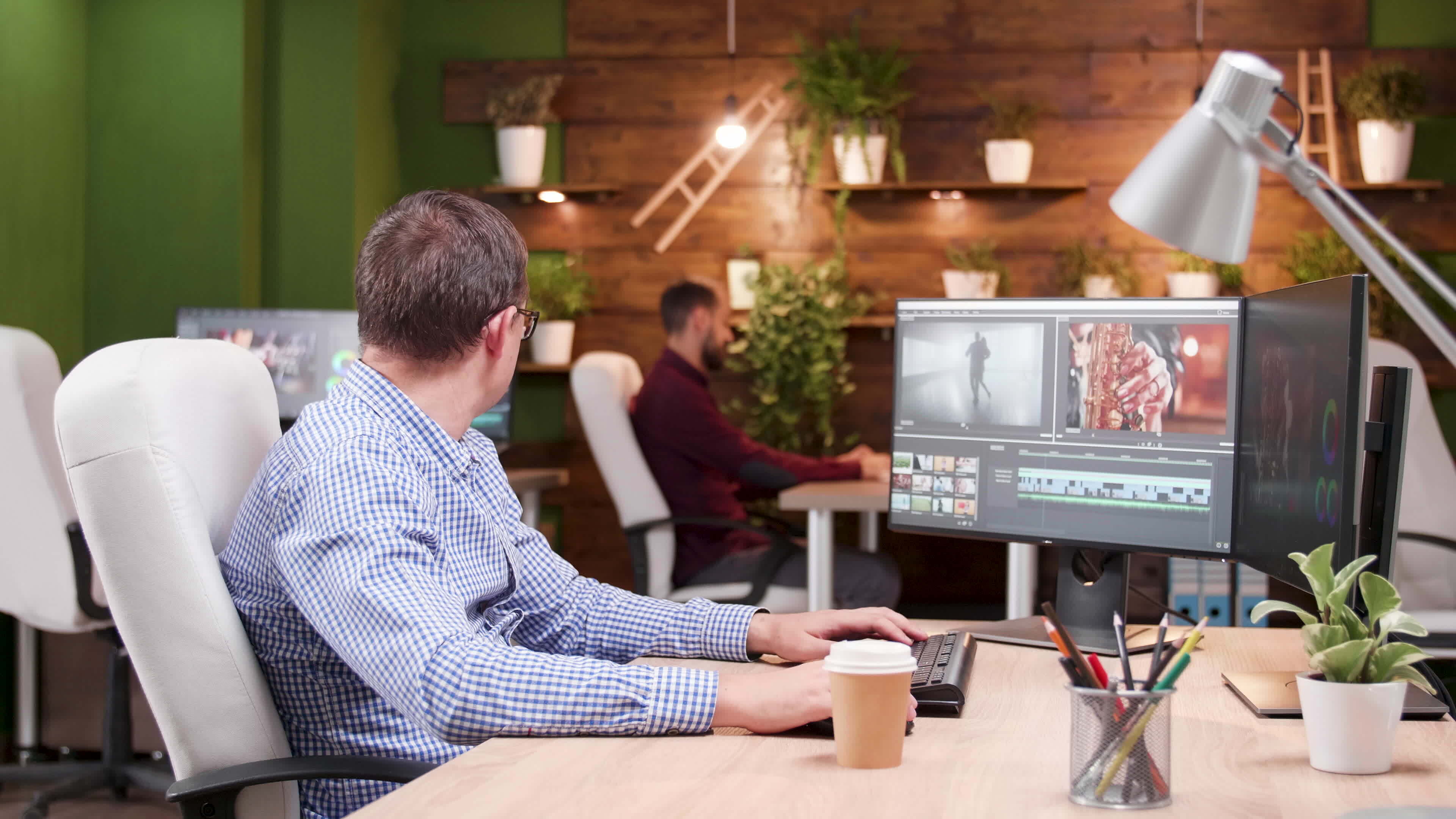 Multimedia manager in the office talking with his assistant video post