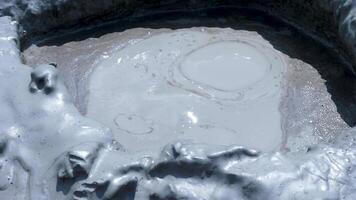 Close up shot of mud volcano gas eruption in hot summer day. Slow motion shot video