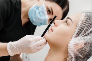 Beautiful young woman getting cosmetology treatment facial skin injection by doctor beautician. Perfect facial proportions after injections. Face correction photo
