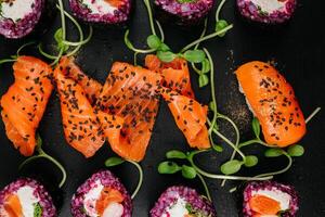 Elegance meets flavor as sushi varieties take their place on a black background, inviting connoisseurs to partake in a visual and gustatory feast at restaurant photo