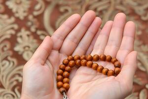 AI generated Wooden Prayer Beads in Hand photo
