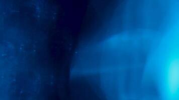 Blue light effect with glow flares over black background. Light effect. Shot in 6K resolution and raw format video