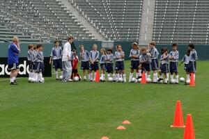 David Beckham demonstrates soccer skills for children after press conference to announce Soccer Academy beginning in Fall 2005 at the Home Depot Center in So California. Carson, CA June 2, 2005 photo