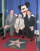 Michael Eisner, Johnny Grant, Mickey Mouse, Robert Iger Disney Store Hollywood Blvd Disney 50th Anniv Special Recongition from Hollywood Trust Los Angeles, CA July 14, 2005 photo