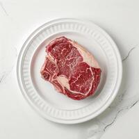 AI generated Prime rib raw meat on a white plate background photo