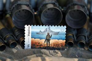 TERNOPIL, UKRAINE - SEPTEMBER 29, 2023 Famous Ukrainian postmark with russian warship and ukrainian soldier as wooden souvenir on army camouflage uniform cloth and machine gun belt photo