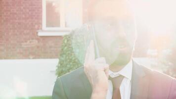 Manager having a conversation on the phone, outdoor in the city. Sof selective focus, slow motion footage video