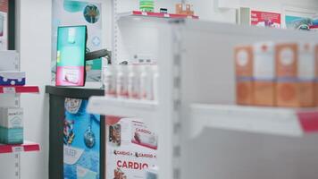 Empty health center with medicine bottles and packages, drugstore shelves loaded with pharmaceuticals. Pharmacy providing prescribed drugs, nutritional supplements and treatment options. video