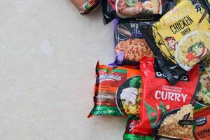 KYIV, UKRAINE - OCTOBER 31, 2023 Many packs of instant noodles for fast cooking by various brands and manufacturers photo