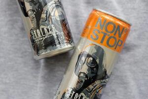 KYIV, UKRAINE - OCTOBER 31, 2023 Non Stop energy drink with limited edition design of Stalker and character with gas mask on aluminium tin can photo