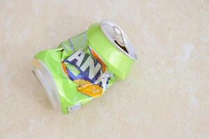 KYIV, UKRAINE - 4 MAY, 2023 Fanta soft drink brand crumpled tin can with exotic flavour photo