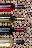 Glass bottle of wine with corks photo