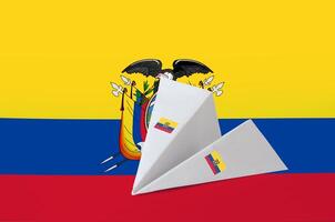 Ecuador flag depicted on paper origami airplane. Handmade arts concept photo