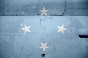 Micronesia flag depicted on side part of military armored helicopter closeup. Army forces aircraft conceptual background photo