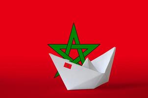 Morocco flag depicted on paper origami ship closeup. Handmade arts concept photo